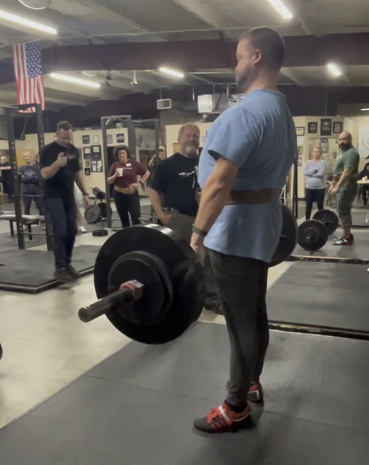 Rip looks approvingly as Gus deadlifts at the Wichita Falls Athletic Club